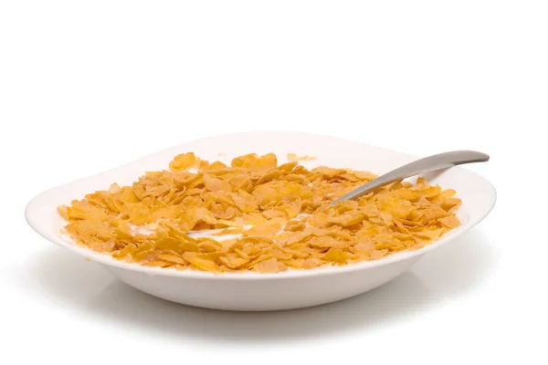 Cornflakes in weißem Teller und Löffel — Stockfoto