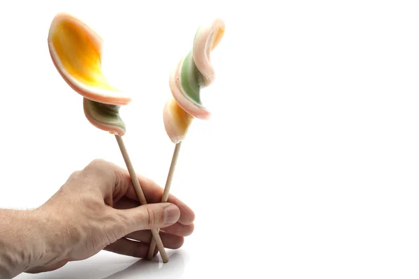 Hand med lollipop — Stockfoto