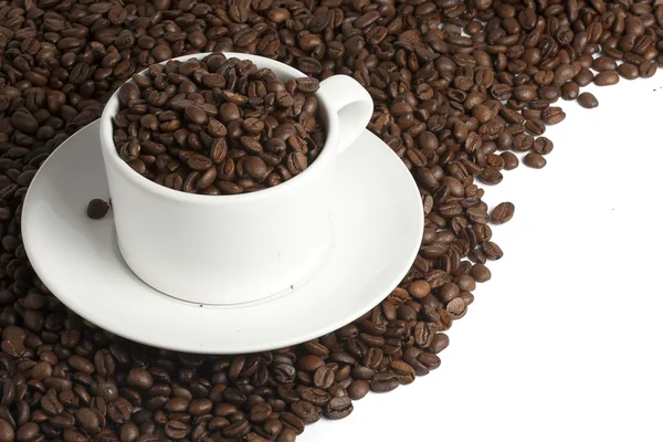 White coffee mug on beans — Stock Photo, Image