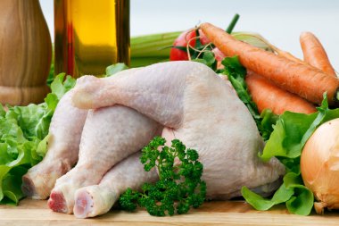 Chicken Leg on board with vegetables clipart