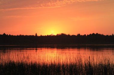 Sunset on the lake. clipart