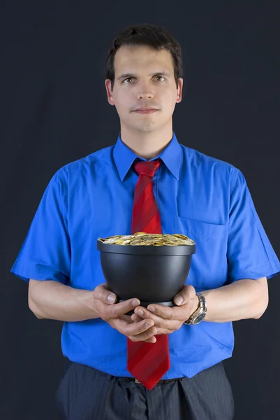Businessman holding a pot with coins. — Stock Photo, Image
