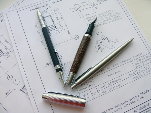 Ручки и карандаш на листе бумаги — стоковое фото