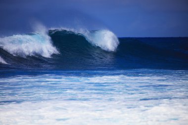 Storm surf surges against Oahu shore clipart