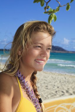 Beautiful young girl with surfboard clipart