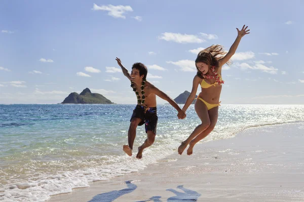 Young couple leaping for joy — Stock Photo, Image