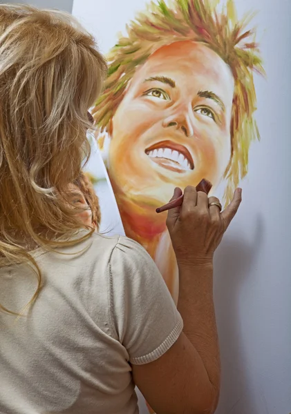 Woman in her fifties painting — Stock Photo, Image