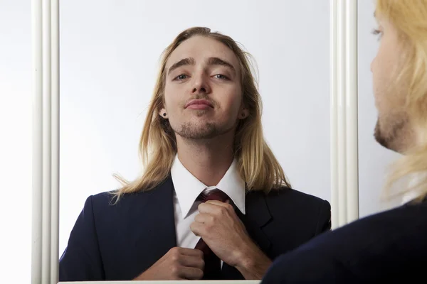 Young man adjusting his tie — Stock Photo, Image