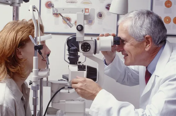 Optiker med patienten Royaltyfria Stockfoton