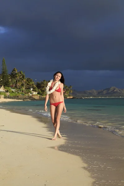 Ung kvinna i röd bikini och en ingefära lei — Stockfoto