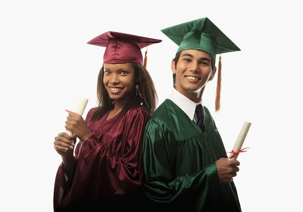 Multi racial couple in cap and gown Stock Image