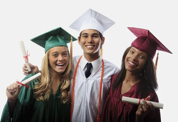 Three graduates in cap and gown Stock Photo