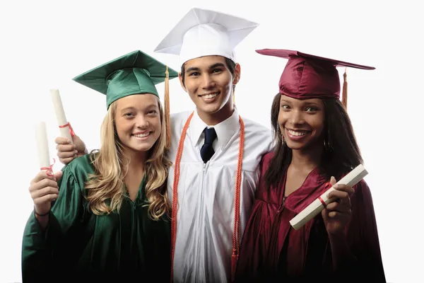Three graduates in cap and gown Stock Image
