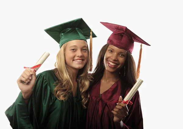 Two female graduates in cap and gown Stock Picture