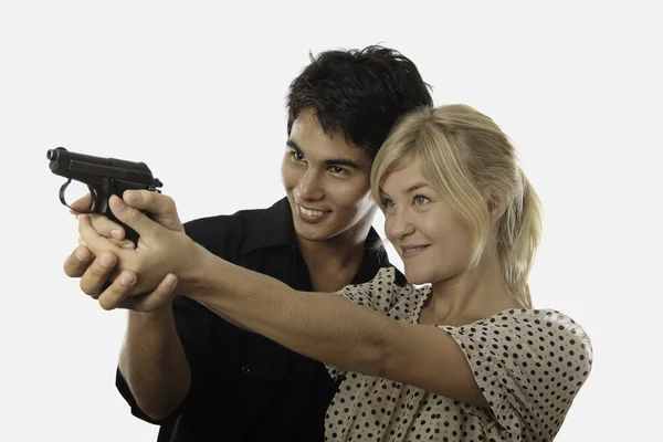 Man and woman with handgun — Stock Photo, Image
