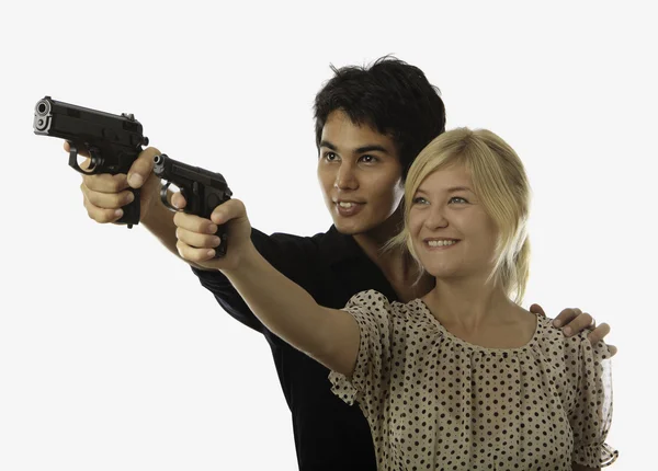 Man and woman with handguns — Stock Photo, Image