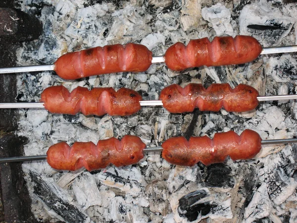 Sausages above hot embers — Stock Photo, Image