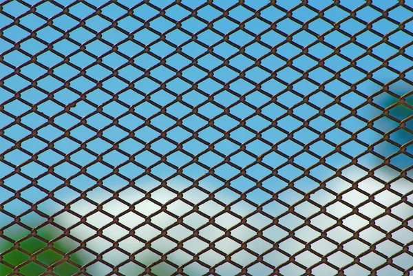 stock image Rusty fence on blue sky
