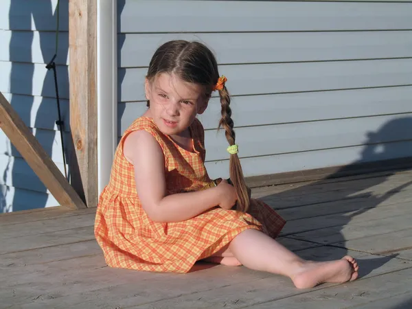 stock image The little girl on a summer verandah