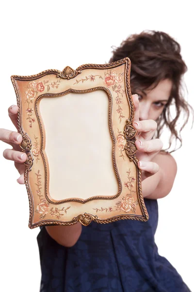 Femme cachant visage avec un cadre photo — Photo