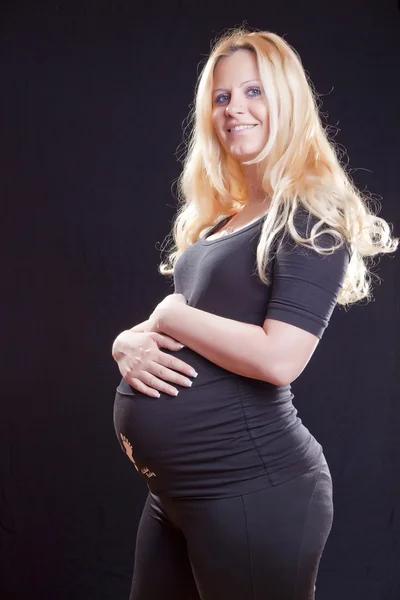 Pregnant woman holding tummy — Stock Photo, Image