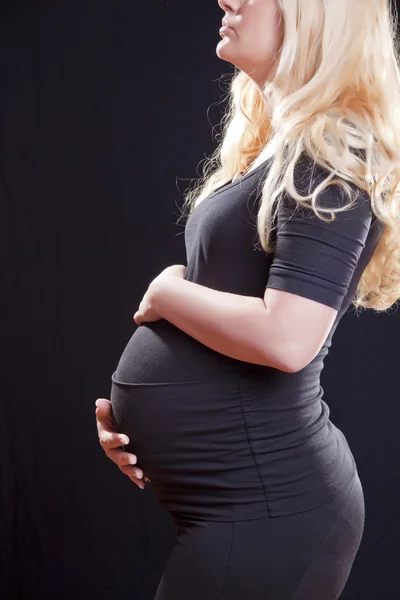 Těhotná žena hospodářství bříško — Stock fotografie