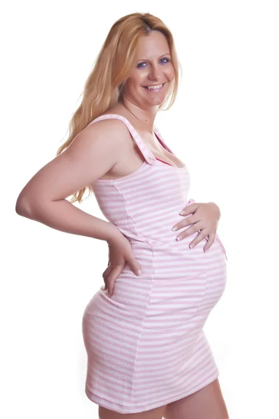 Mosolygó terhes nő tartja, pocakját — Stock Fotó