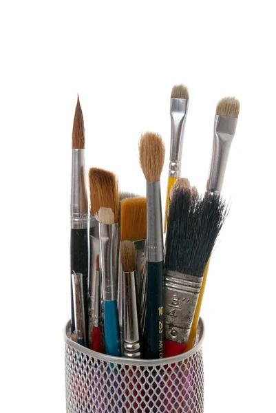 Paintbrushes in a metal mesh holder — Stock Photo, Image