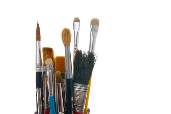 Assorted Dirty Painting Brushes In Glass Flask Stock Photo