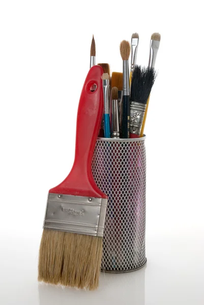 Paintbrushes in a metal mesh holder — Stock Photo, Image