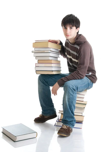 De jonge student met de boeken — Stockfoto