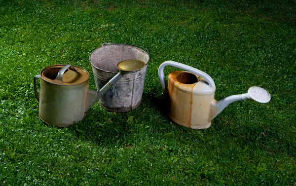 Watering cans and a bucket — Stock Photo, Image