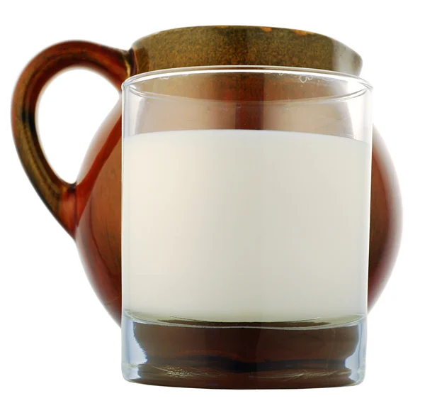 Glas met een witte vloeistof en pot — Stockfoto