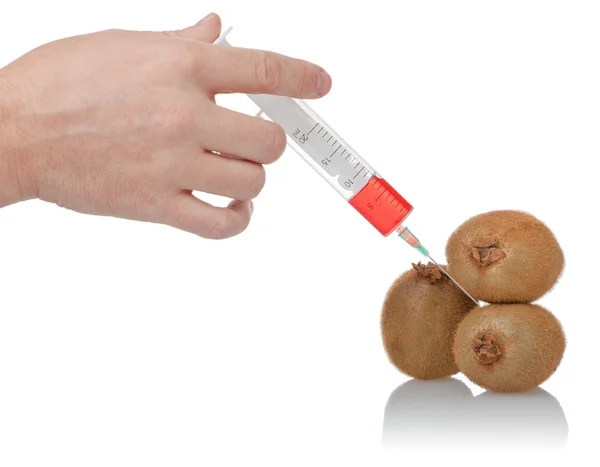 Hand holds the syringe on kiwi — Stock Photo, Image