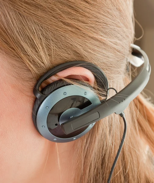 Ear with headphones — Stock Photo, Image