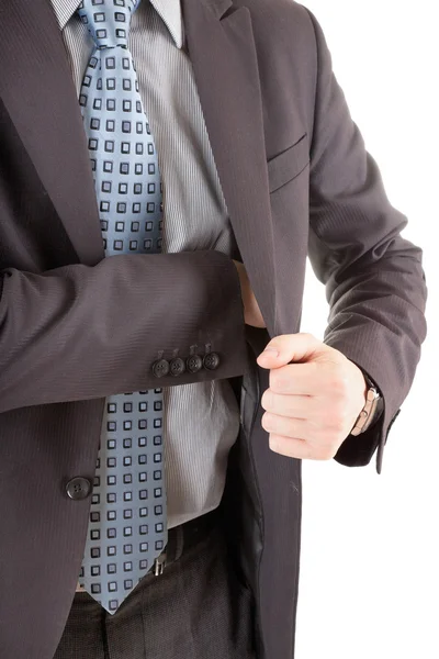 Бизнесмен тянется к своему карману — стоковое фото
