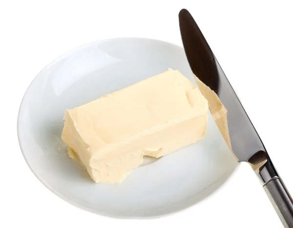 Piece of butter on a saucer and knife — Stock Photo, Image