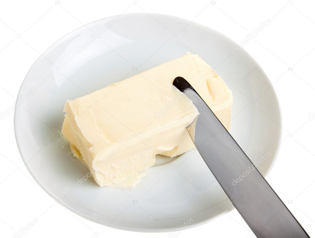 Piece of butter on a saucer and knife