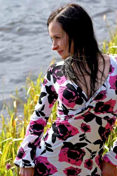 Mulher sentar-se na lagoa de outono — Fotografia de Stock