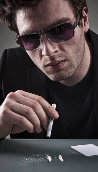 Junger Mann schnuppert Kokain. — Stockfoto