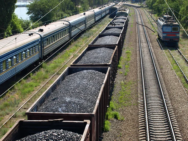 Freight train with coal and passenger train. — Stock Photo, Image