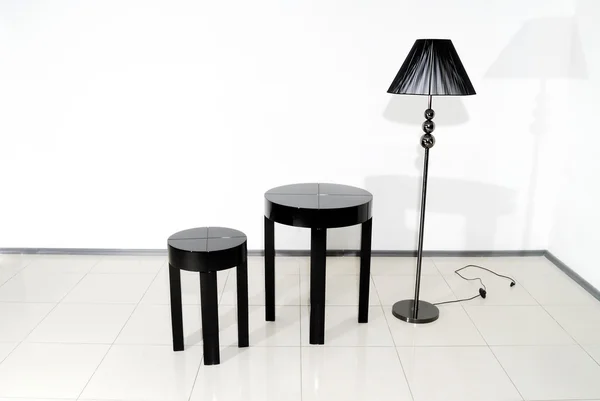 Μαύρη καρέκλα, τραπέζι και φωτιστικό δαπέδου — Φωτογραφία Αρχείου