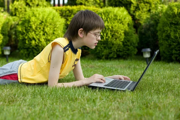 Boy and laptop in nature