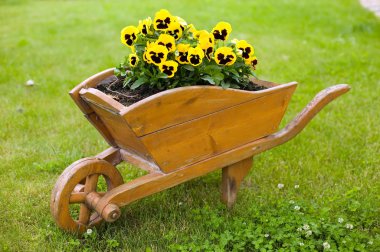 Brown barrow with yellow flowers clipart