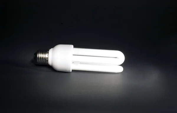 Electric bulb on red background — Stock Photo, Image