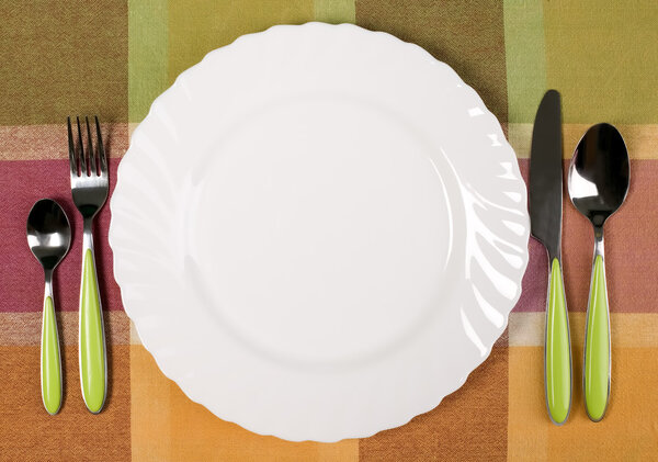 Plate with knife and fork on the table
