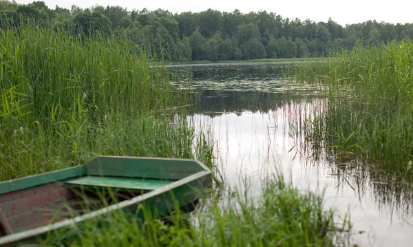 stock image Grey boat and the lake