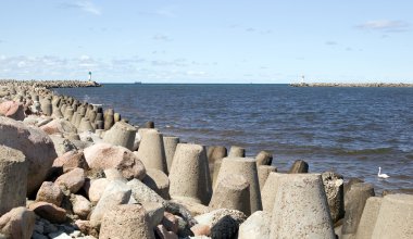 Huge stone with sea in background clipart