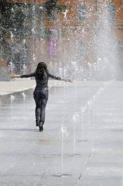 Young girl running under the water clipart