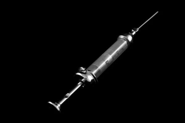 Syringe on a black background — Stock Photo, Image